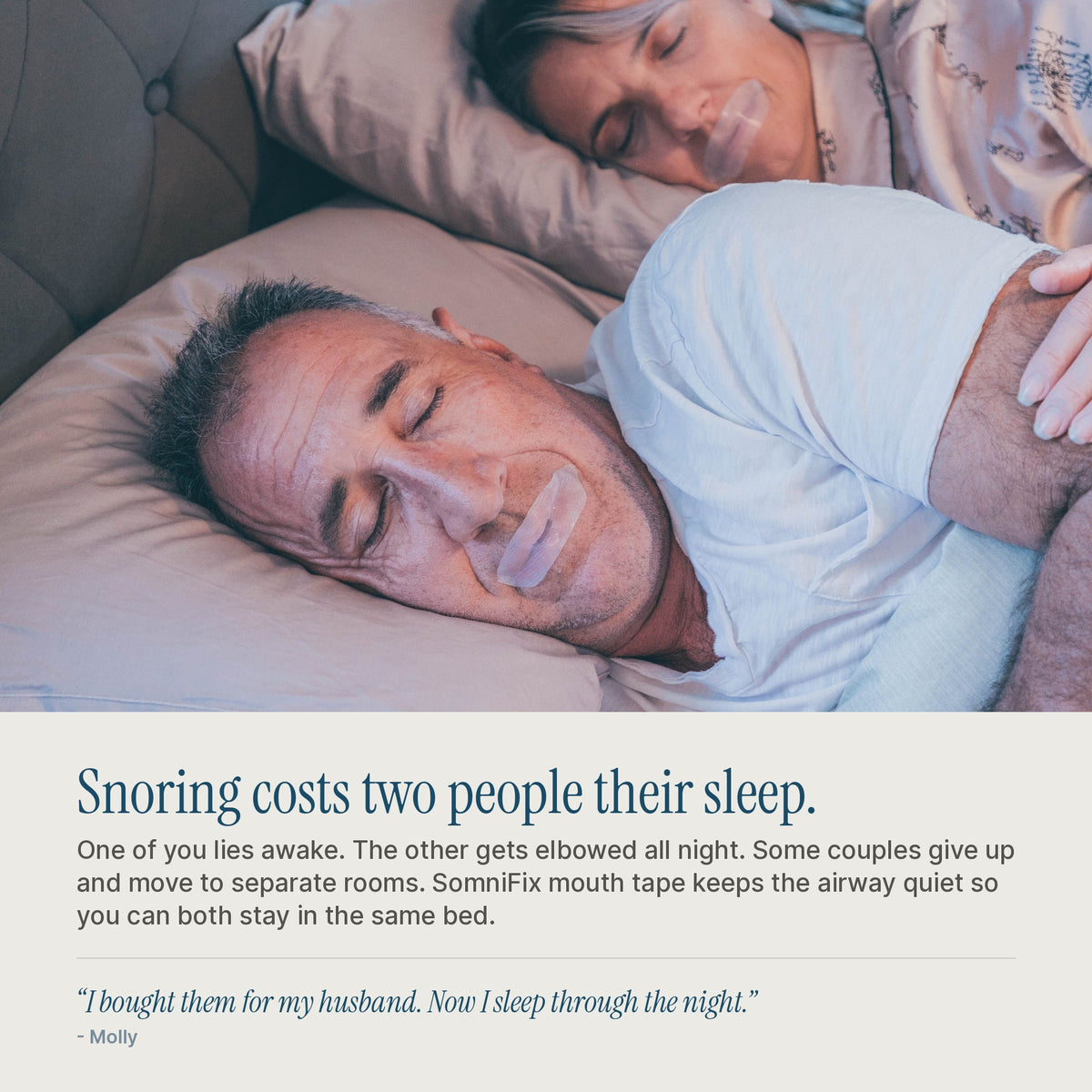 Couple asleep in bed, one wearing SomniFix mouth tape, which quiets the airway so both partners stay asleep.